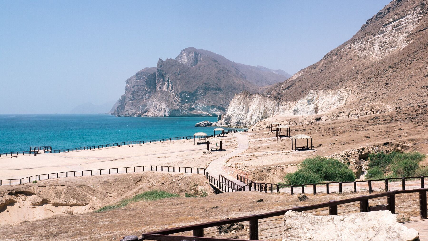The Dhofar coast at Mughsayl near Salalah: turquoise sea beneath white cliffs and a rocky headland