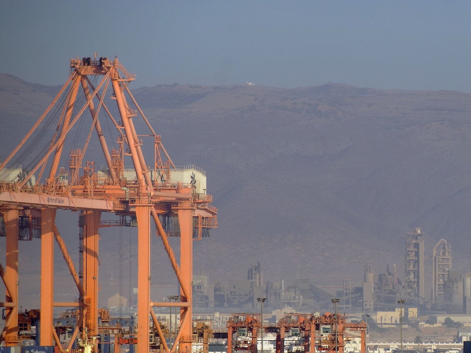 A quay crane at the Port of Salalah with the Dhofar mountains behind
